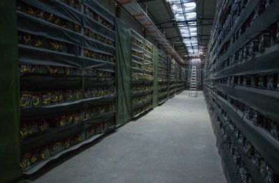 An expansive Bitcoin mining farm illuminated by LED-lit ASIC miners