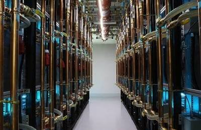 A modern mining farm facility showcasing rows of mining rigs under controlled lighting